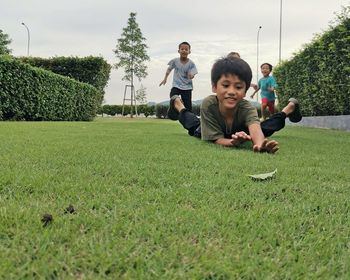 High angle view of children on grass against trees