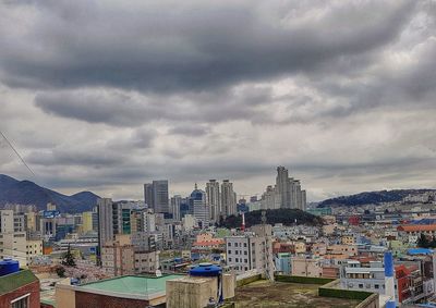 Cityscape against cloudy sky