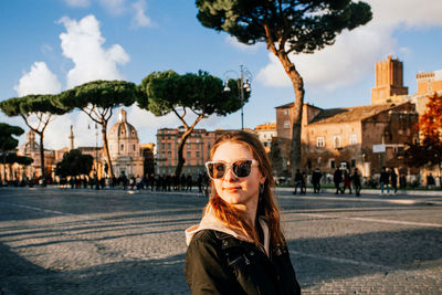 Portrait of young woman in city