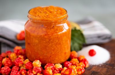 Close-up of oranges in glass jar on table