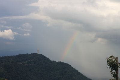Rainbow over mountain against sky