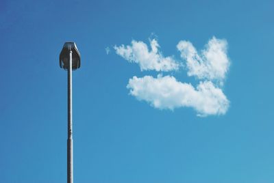 Low angle view of street light against blue sky