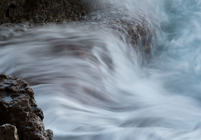 Close-up of water flowing over rocks