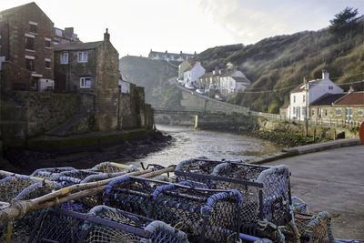 Fishing net on house by buildings against sky