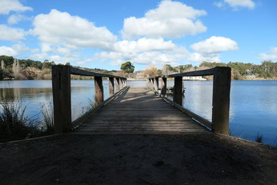 Pier over lake against sky