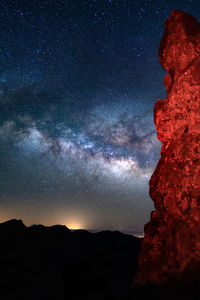 Scenic view of mountains against sky at night