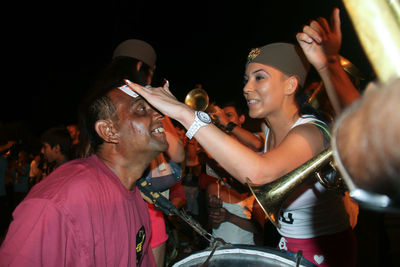 People enjoying event on street at night