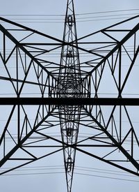 Low angle view of electricity pylon against clear sky