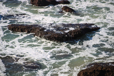 High angle view of water flowing in sea