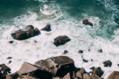 High angle view of rocks in sea