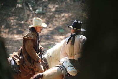 Rear view of people wearing hat