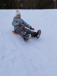 Man skiing on snow covered field