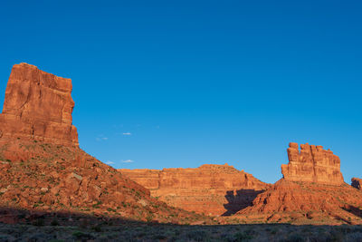 Landscape of red buttes against blue sky in the valley of the gods in utah