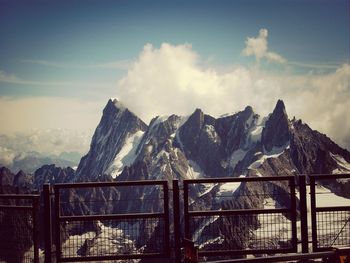 Scenic view of mountains against cloudy sky