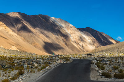 Scenic view of mountains against clear blue sky