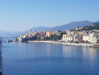 Town by sea against clear sky