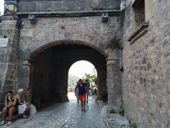 Rear view of people walking in historical building