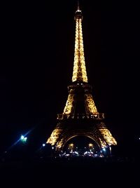 Low angle view of illuminated tower at night