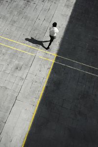 High angle view of man walking on road