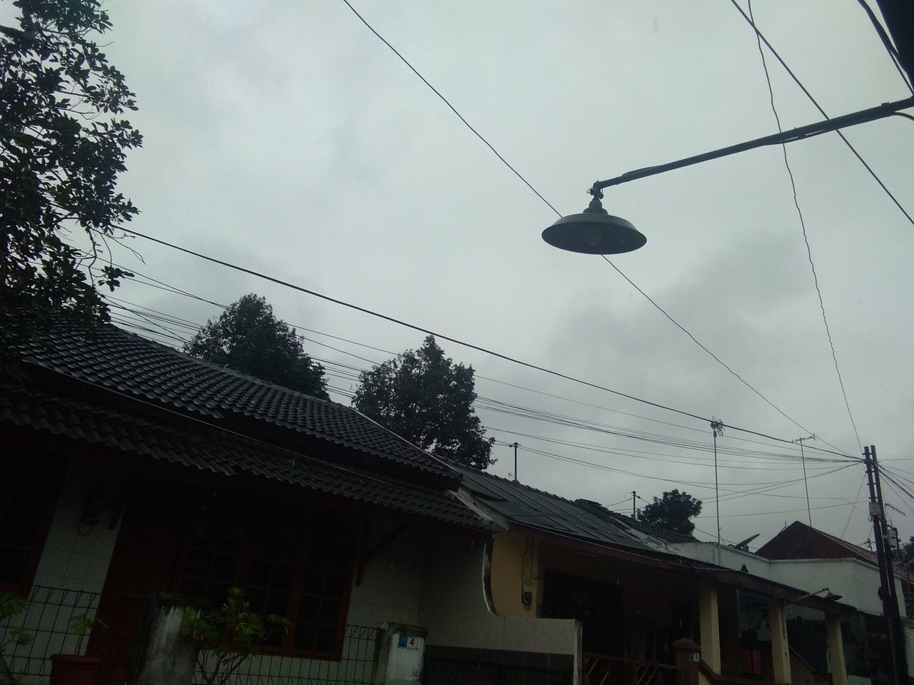 LOW ANGLE VIEW OF POWER CABLES AGAINST SKY