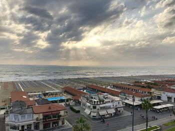 High angle view of buildings by sea against sky
