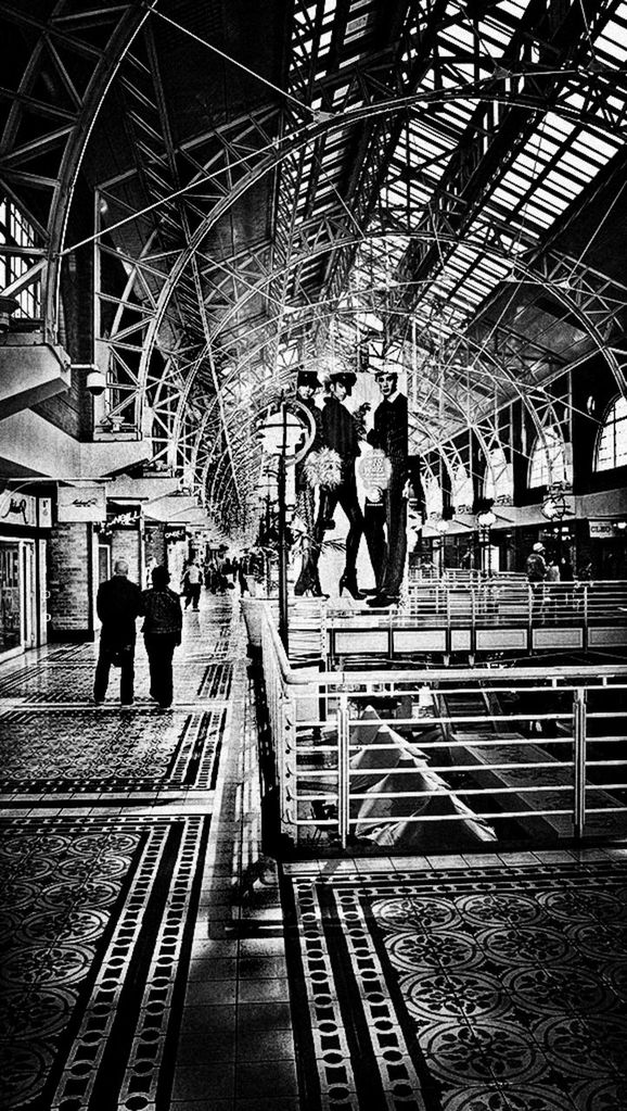 indoors, lifestyles, men, architecture, built structure, ceiling, person, leisure activity, large group of people, walking, travel, railroad station, full length, the way forward, rear view, incidental people, travel destinations, pattern, metal