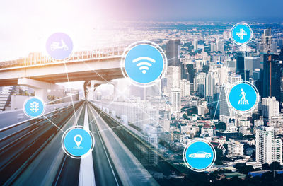 Digital composite image of road and buildings against blue sky