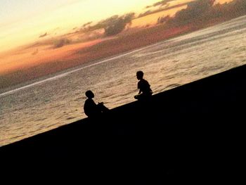 Silhouette of people at sunset