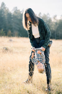 Young woman standing on field