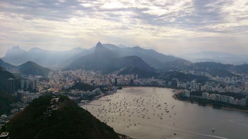 Panoramic shot of cityscape by sea against sky