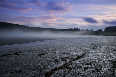 Scenic view of frozen lake against sky during winter