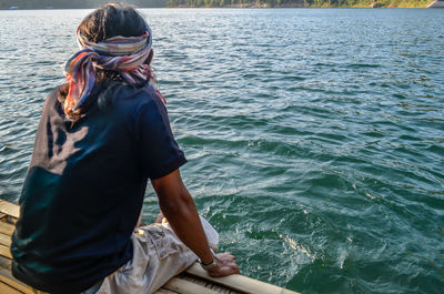 Rear view of woman standing in sea