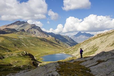 Man standing by lake at countryside landscape