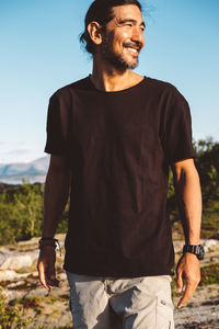 Man smiling on a mountain in a sunny day