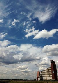 Low angle view of building against cloudy sky