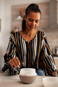 Portrait of young woman using mobile phone