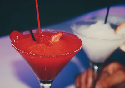 Close-up of hand holding glass of juice