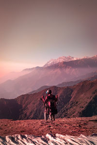 People standing on mountain against sky