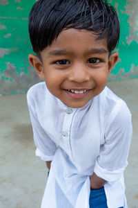 Portrait of smiling boy standing outdoors