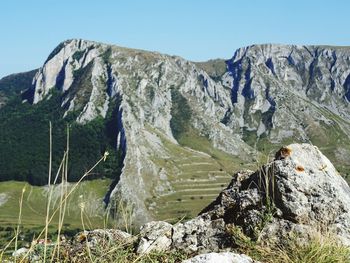 Panoramic view of rocks and mountains against clear sky