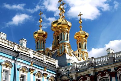 Low angle view of church against cloudy sky