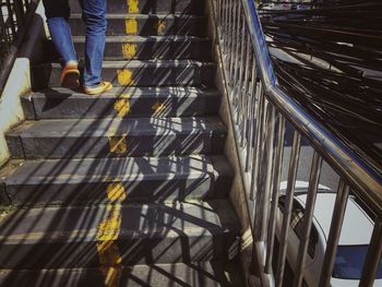 Low section of people walking on staircase