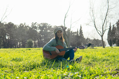 Young woman sitting on field