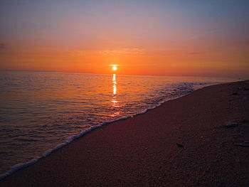 Scenic view of sea against romantic sky at sunset