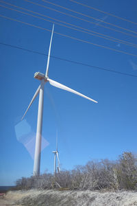 Low angle view of windmill against sky