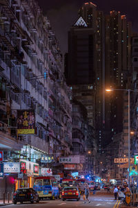 View of city street and buildings at night