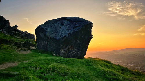 Scenic view of rocks against sky during sunset