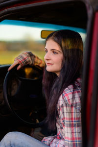 Portrait of woman in red truck