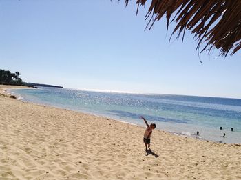 Scenic view of beach against blue sky