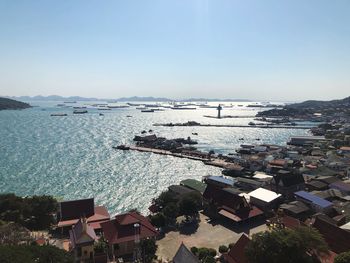 High angle view of townscape by sea against sky